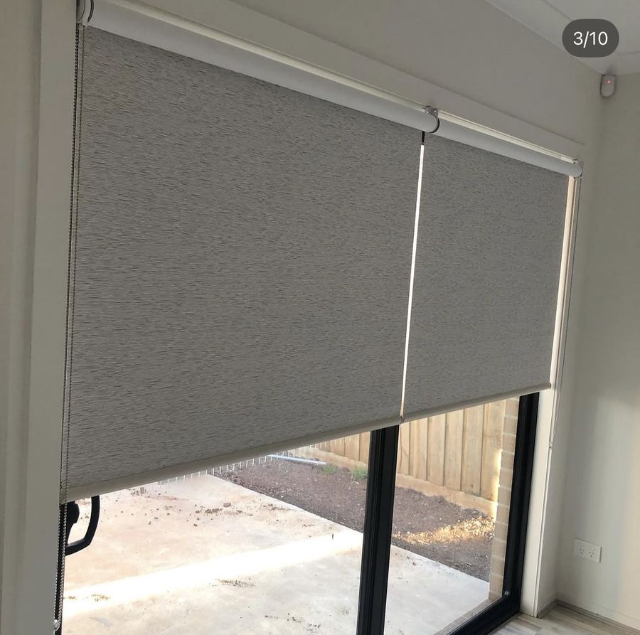 Charcoal roller blind fitted over a sliding glass door